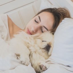 girl and her dog in the bed.