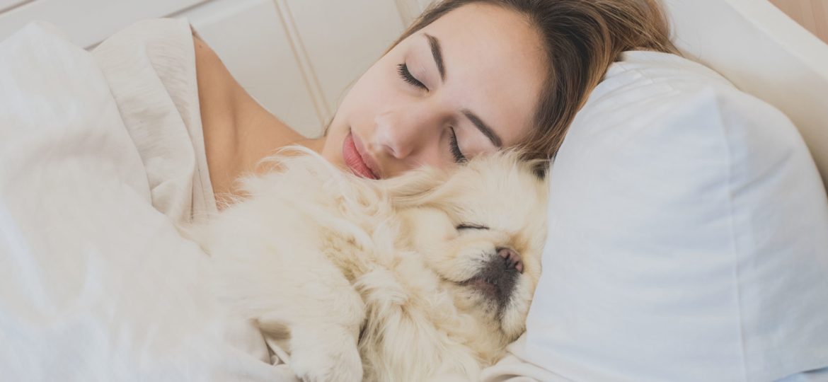 girl and her dog in the bed.